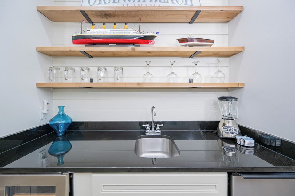 Mix up cocktails or pour refreshing drinks at your wet bar, surrounded by charming coastal decor