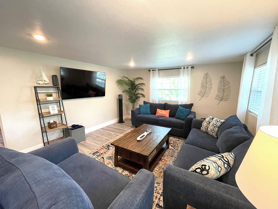 Living room w 65” Smart TV and plenty of seating