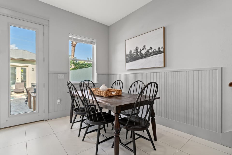 Downstairs dining table with view of outside patio and pool