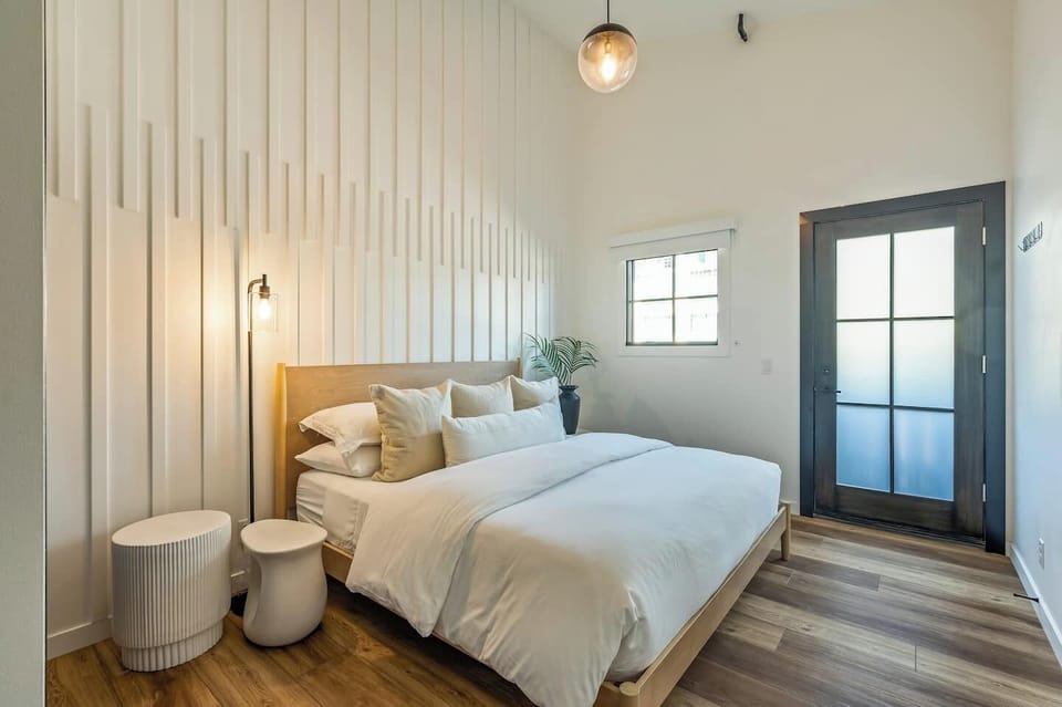 Upstairs bedroom with king bed, and balcony access. 