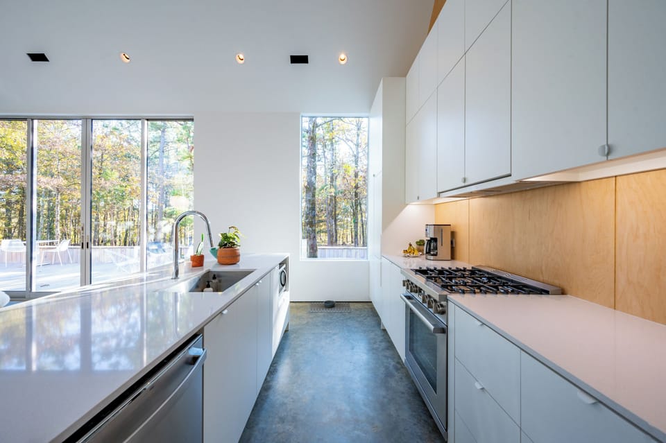 Kitchen Bliss: Enjoy gourmet cooking in a sunlit space with modern appliances and forest views!