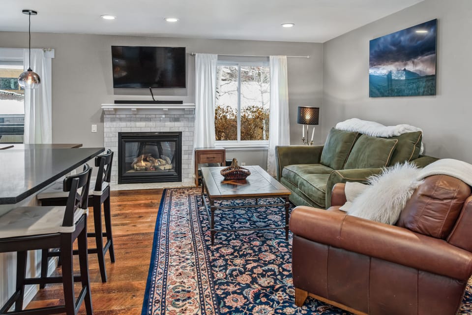 Living are and fireplace.  Beautiful views and natural light. Smart TV soundbar.