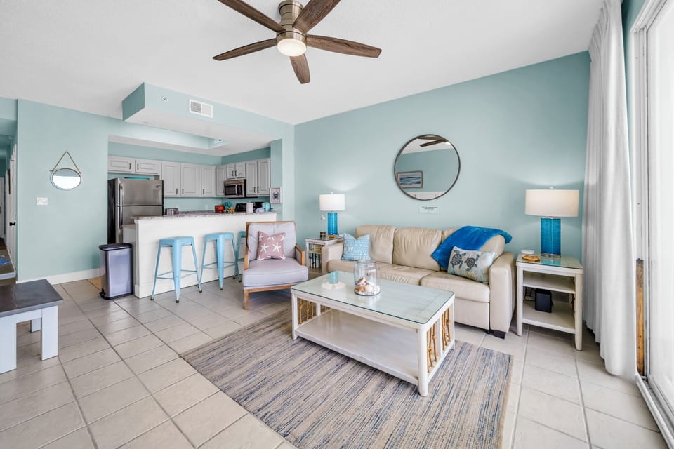 Sink into plush seating in your bright, coastal-inspired living space where soothing colors and modern comforts create the perfect retreat.