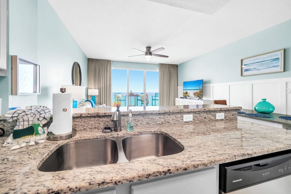 Your gourmet kitchen features granite countertops and stunning ocean views, perfect for preparing meals while enjoying the coastal breeze.
