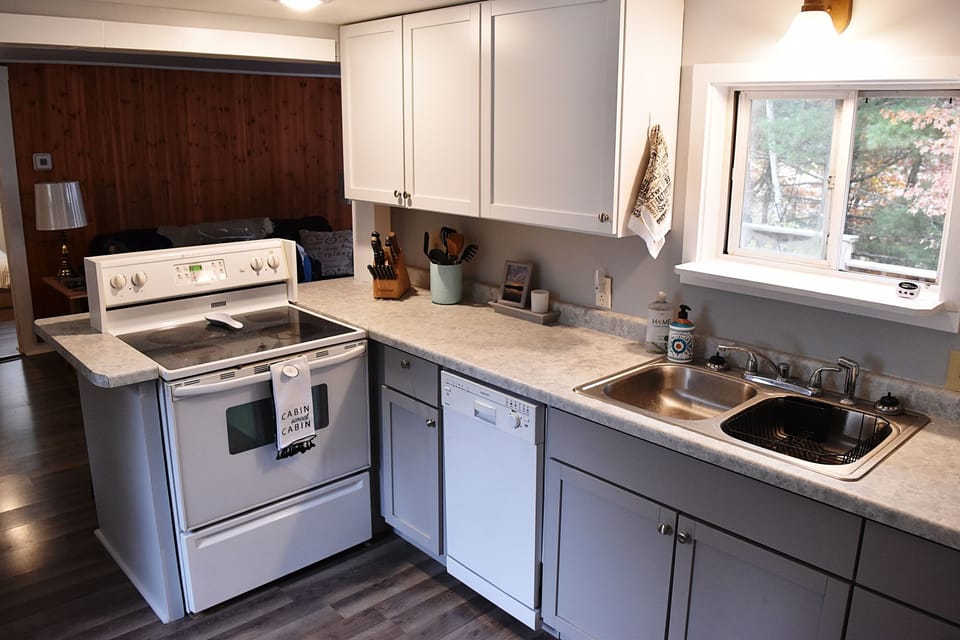 Kitchen, with range, sink and dishwasher. Cooking and serving utensils included.
