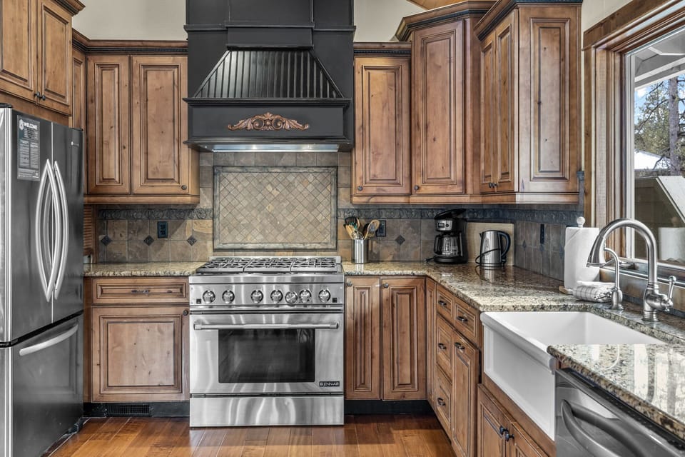 Step into your gourmet kitchen where rich wood cabinetry meets granite countertops, creating the perfect space for memorable meals together.