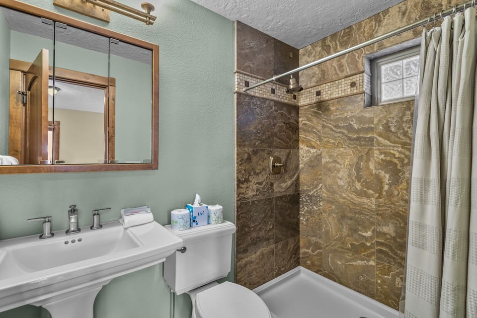 Your elegant bathroom features marble-look tile and all the essentials for a refreshing stay.