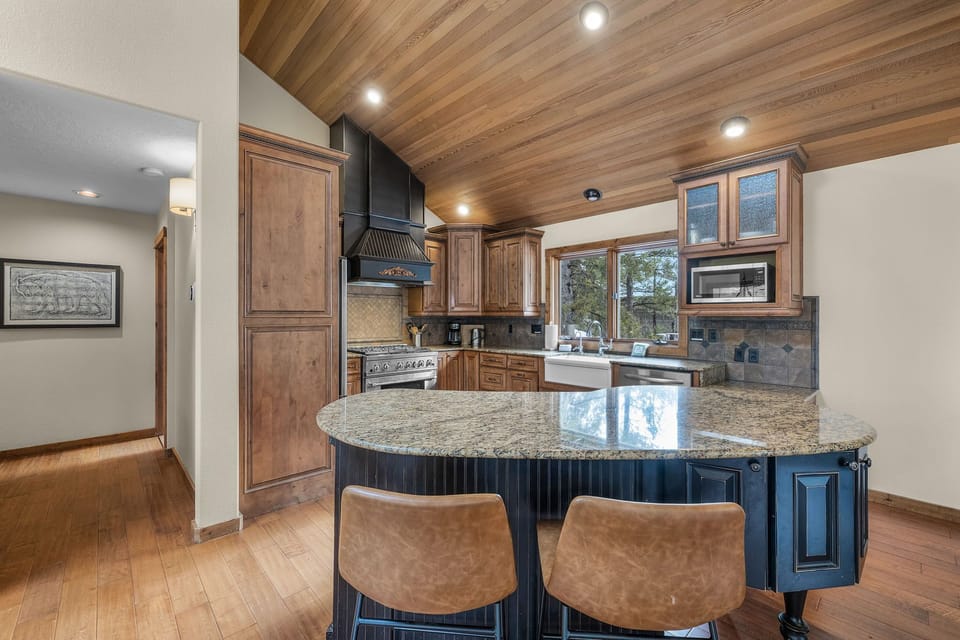 Your gourmet kitchen features granite countertops, professional appliances, and a spacious island perfect for meal prep and casual dining.