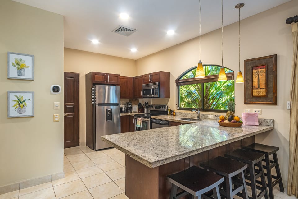 The kitchen features bar seats for 4, stainless appliances, herbs & spices, +!