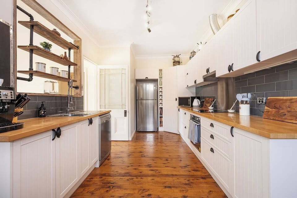 The galley kitchen offers an easy layout and is equipped with a stove & oven, dishwasher and cooking utensils for preparing meals at home.