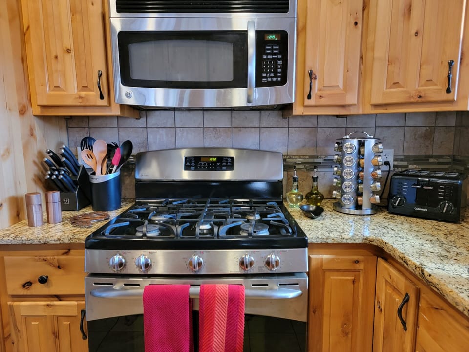 Kitchen with cooking essentials like salt, pepper, sugar, oil and common spices