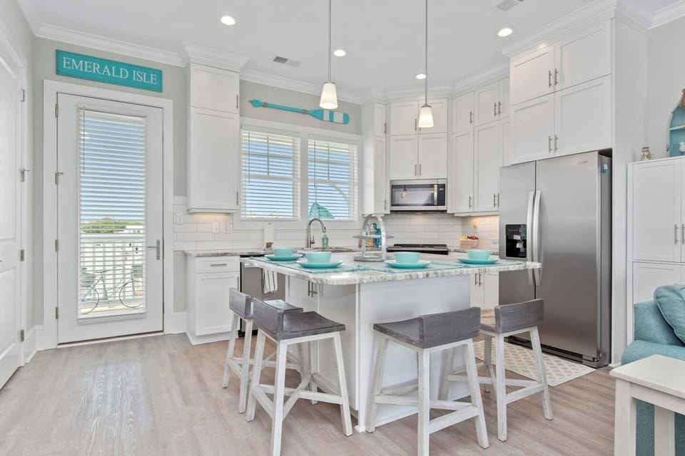 Cook in style!  Our bright, fully equipped kitchen features custom white cabinetry, granite countertops, and a cozy island with seating for four. Who’s ready to whip up something delicious?