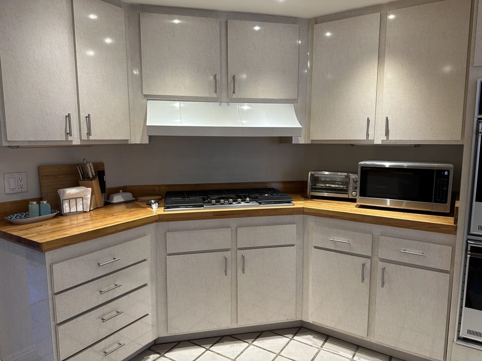 Vintage kitchen with upgraded stainless appliances.