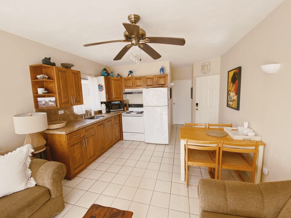 Eat-in kitchen with dining table that sits four - perfect to invite guests over!