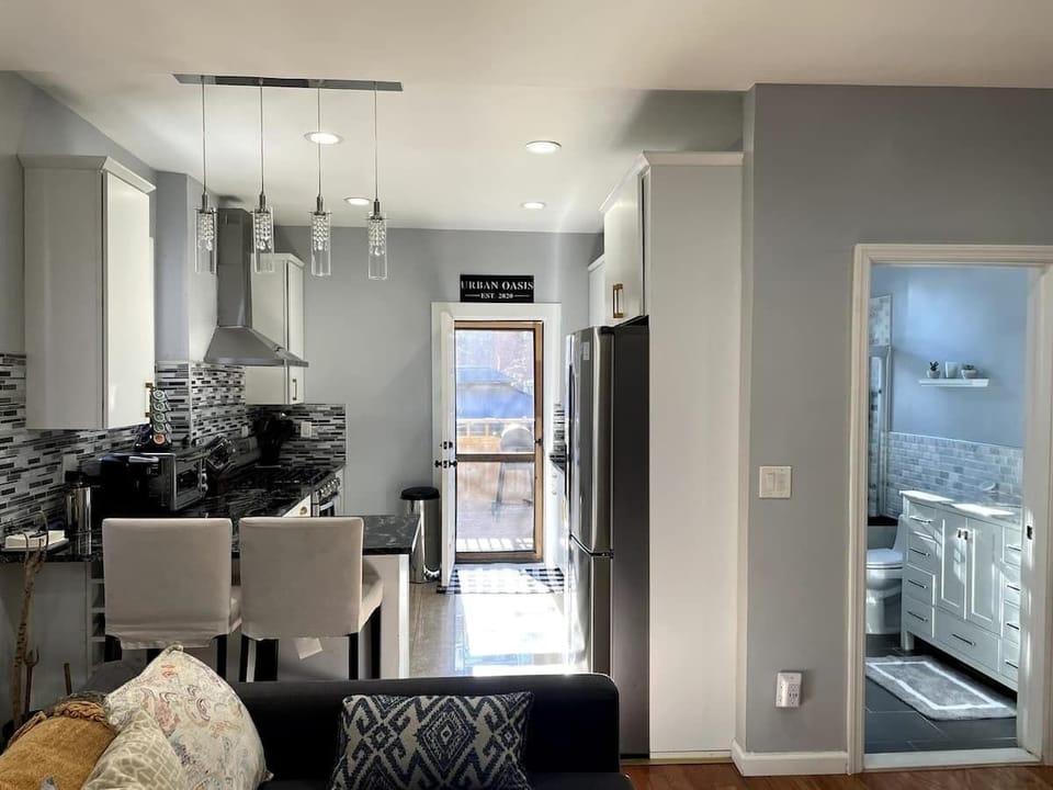 Main living space including living room, open-concept kitchen, and full bath. Access to private backyard (aka Urban Oasis).