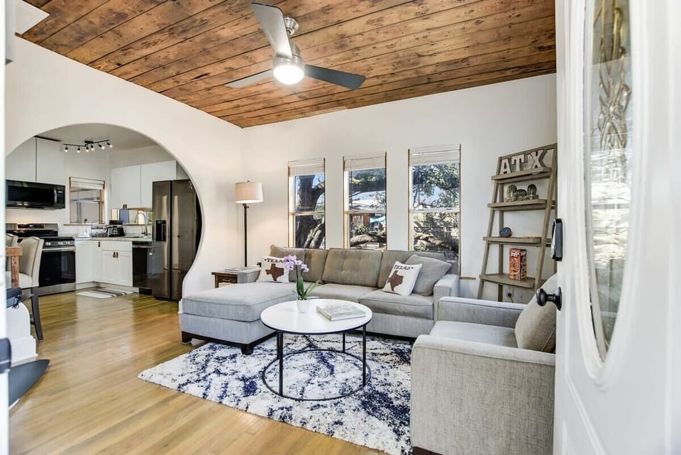 The front porch entrance opens up to the living room and arched wall to the kitchen and dining room.