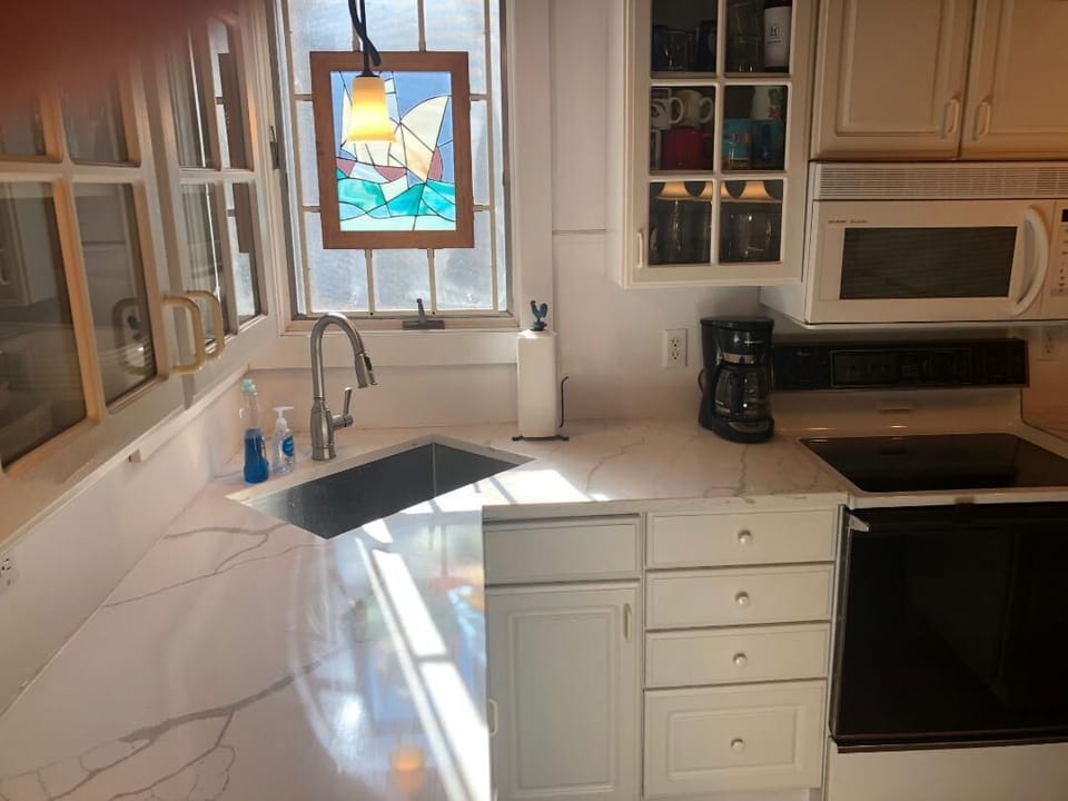 Modern updated kitchen with new granite counter tops and SS appliances. 