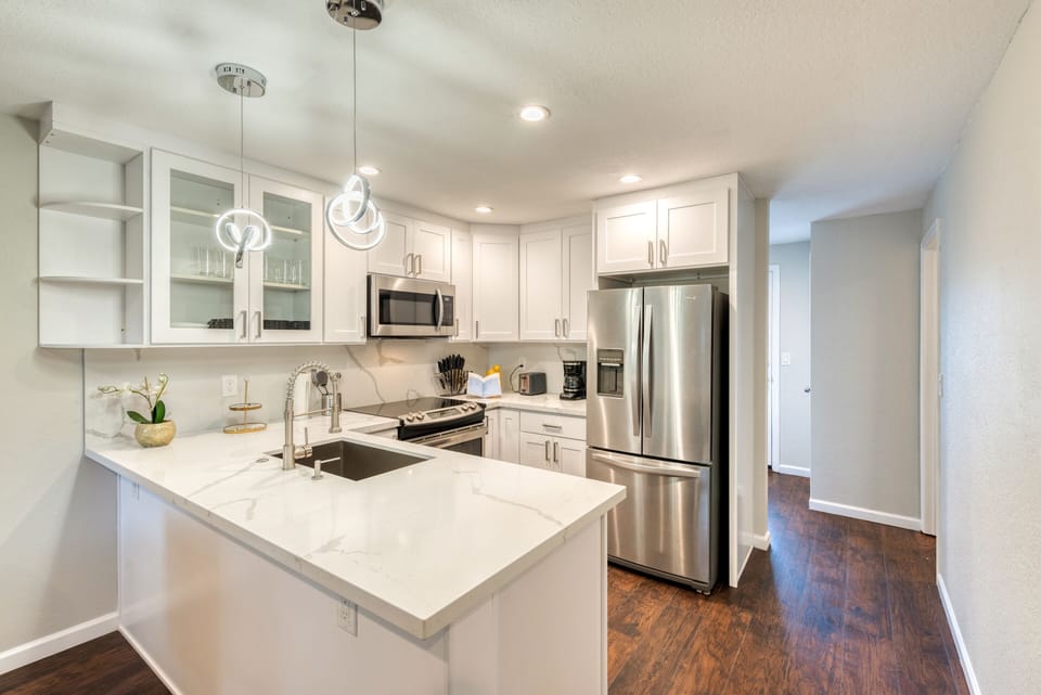 Completely remodeled kitchen with stainless steel appliances and quartz counter
