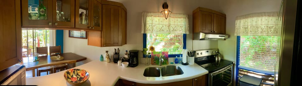 Kitchen and pass through to dining room with bar glasses.