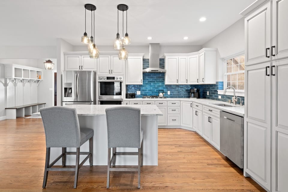 Indulge in the luxury of high-end Samsung appliances, white quartz countertops and island seating.
