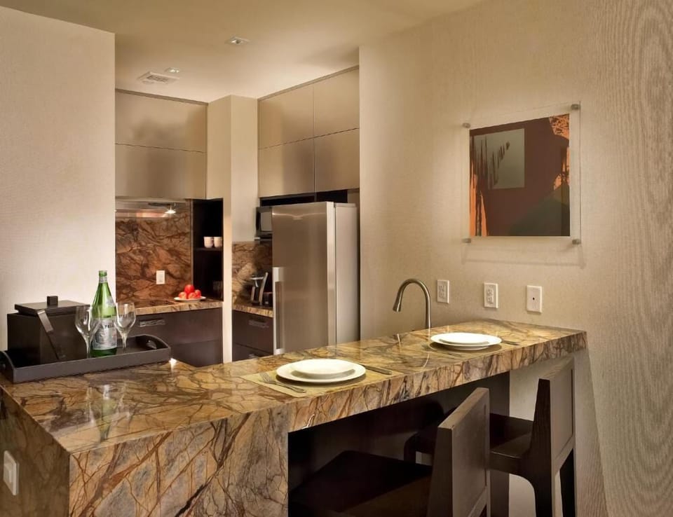 Sip and snack at the marble breakfast bar with sleek appliances.