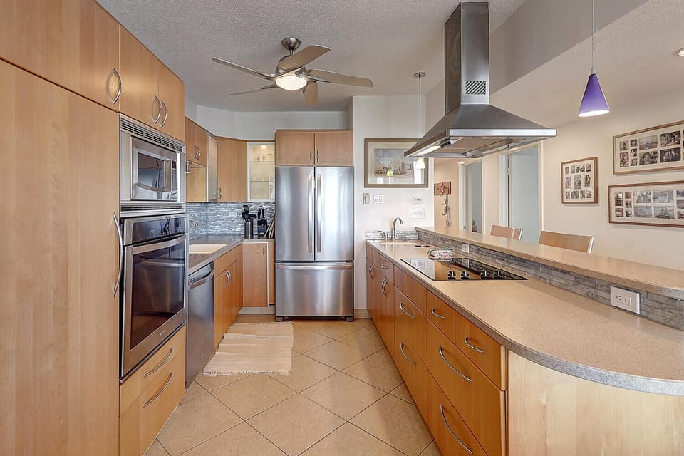 Your gourmet kitchen awaits with stainless steel appliances, granite countertops, and modern wood cabinetry for memorable meal preparation.