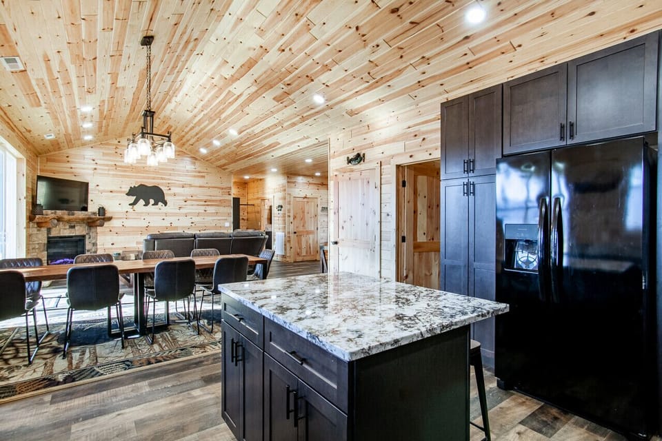 Spacious cabin kitchen with modern design, granite island, and style