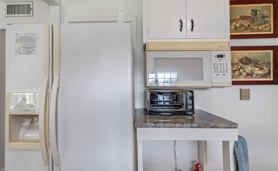 Kitchen is fully stocked, with full sized fridge, freezer, stovetop, oven, toaster oven, microwave, and coffeemaker.