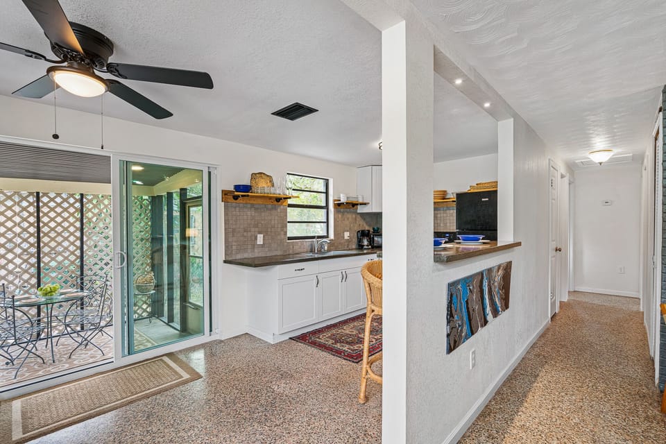 View of patio, kitchen, and hallway to bedrooms.