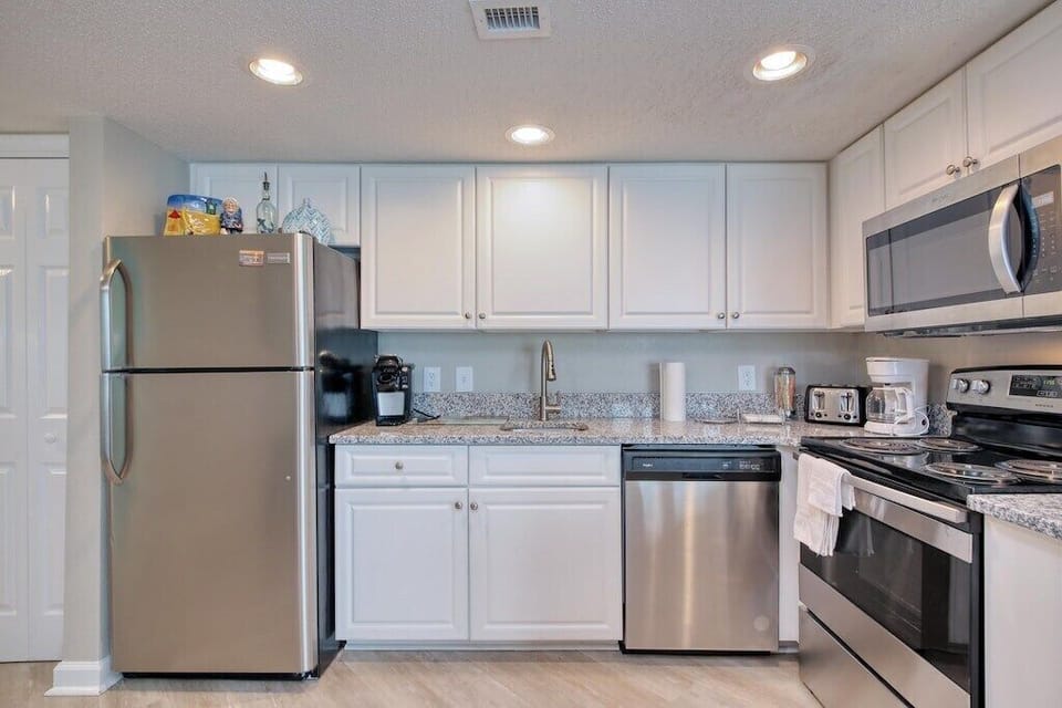 Kitchen: Bright and modern with stainless steel appliances and ample counter space for culinary adventures!
