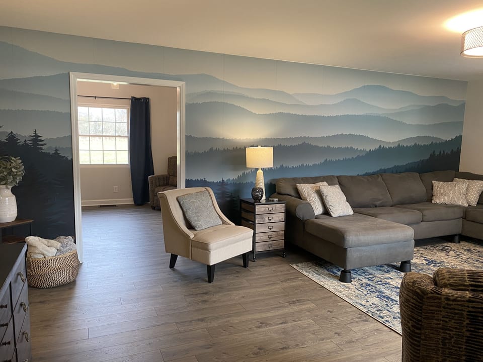 The mountain mural and calming decor evoke a sense of peace upon entering.