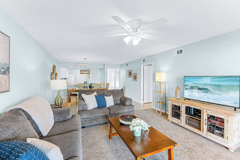 Step into this bright and welcoming living room with comfy seating and calming beach tones.