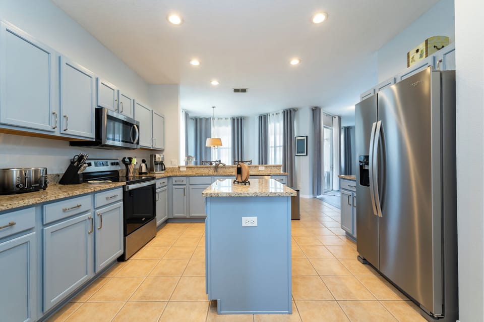 Modern kitchen with Island and stainless steel appliances.