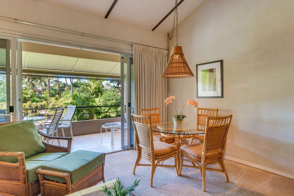 Indoor dining for four with views of tropical gardens and access to the lanai.