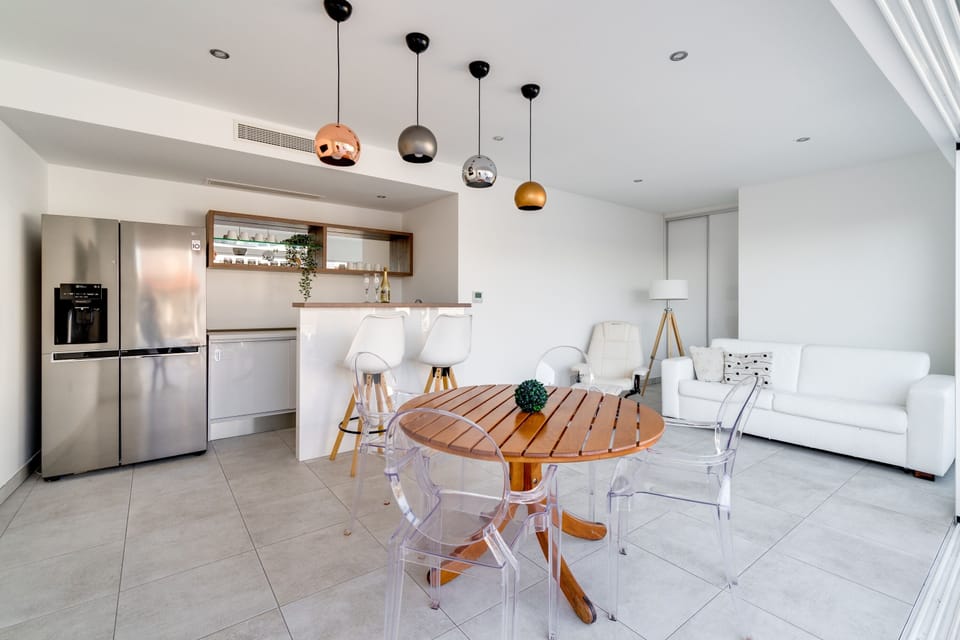 Modern summer kitchen and lounge area next to the pool
