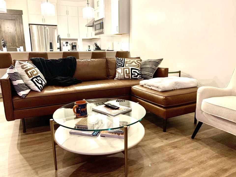 Living room has a tv, gas fireplace and access to balcony via sliding glass door