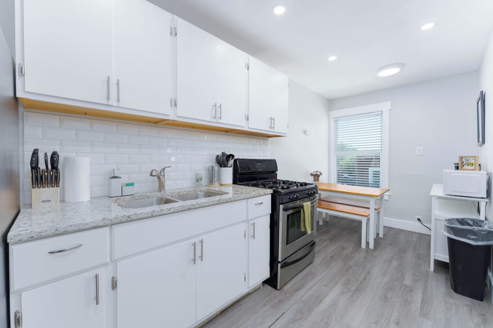 Indulge in the culinary experience with an adjacent dining enclave, elevating mealtime moments. The pristine kitchen boasts luminous white cabinets, a stove, and ample counter space, exuding modern sophistication. Essential appliances like a refrigerator and dishwasher complement the well-maintained ambiance.