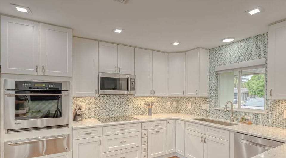 Open layout fully appointed eat in kitchen with island for 4, stainless steel refrigerator with filtered water/ice maker, Keurig machine for pod or regular drip coffee, toaster, microwave, filtered water etc.  Look on listing for a detailed list of everything located  inside kitchen. 