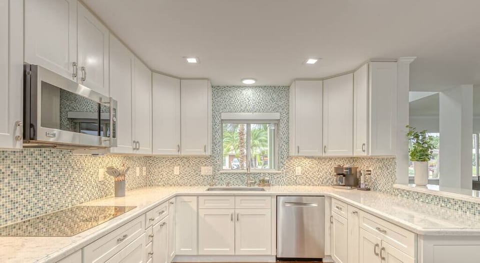 Open layout fully appointed eat in kitchen with island for 4, stainless steel refrigerator with filtered water/ice maker, Keurig machine for pod or regular drip coffee, toaster, microwave, filtered water etc.  Look on listing for a detailed list of everything located  inside kitchen. 