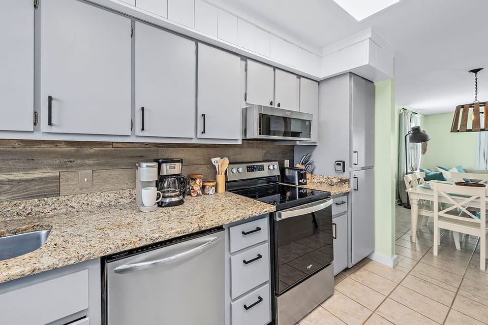 Stocked kitchen opens to the dining area. Coffee bar with Keurig and drip coffee maker.  Coffee & sugar provided!