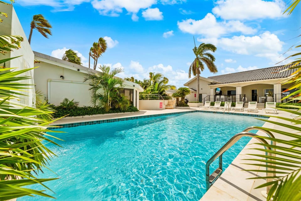 Dive into relaxation at our expansive pool, complete with ample seating options for soaking up the sun's rays.