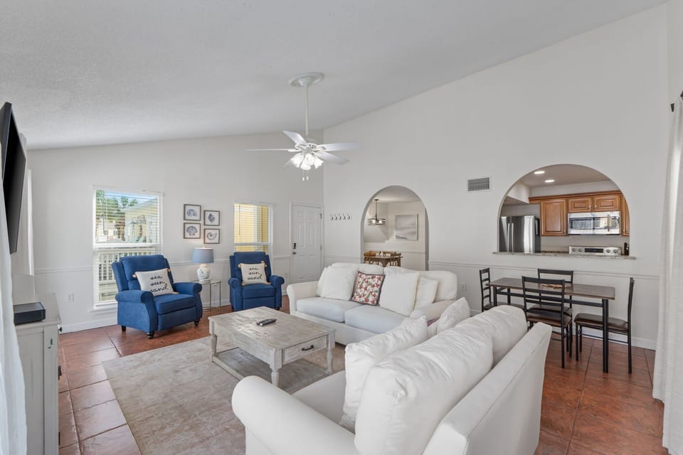 Relax in your spacious open-plan living area with comfortable seating and modern amenities for the perfect vacation retreat.