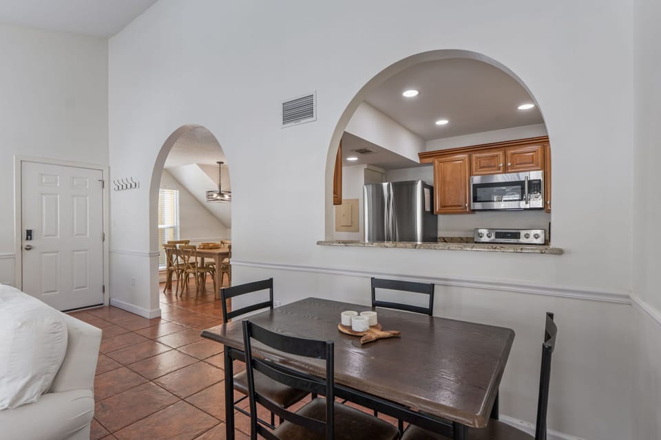 Gather around your private dining table while staying connected to the kitchen through elegant archways.