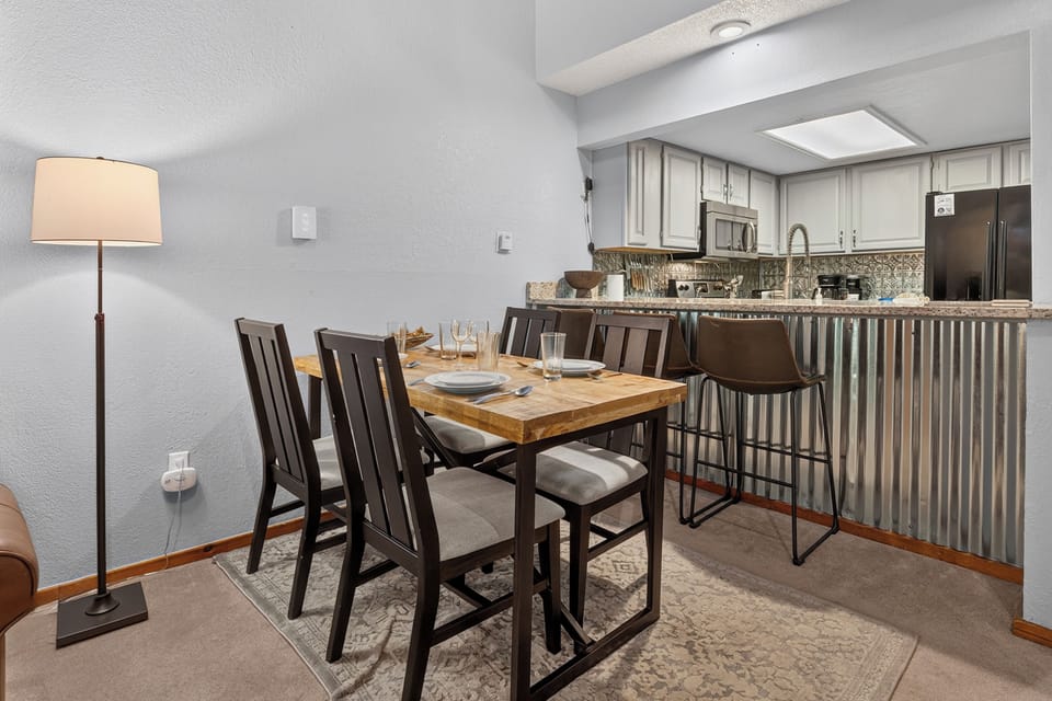 Gather around your stylish dining table for four or settle into the bar seating—your fully equipped kitchen makes it easy to whip up meals together and enjoy the warm, inviting glow of home.