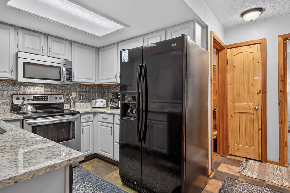 Step into your fully-equipped kitchen with granite countertops, modern appliances, and plenty of space to whip up a delicious meal or morning coffee during your stay.