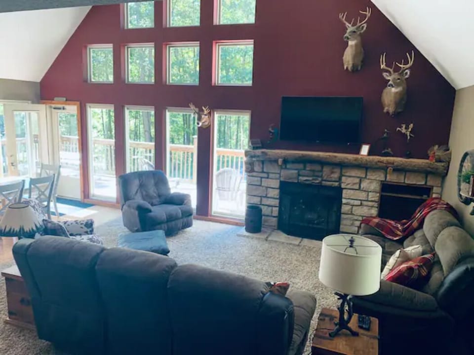 Great Room with wood burning fireplace and 55” smart tv