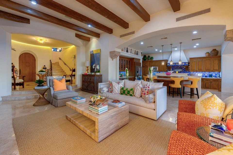 Another seating area next to the kitchen with multiple chairs and a custom coffee table.