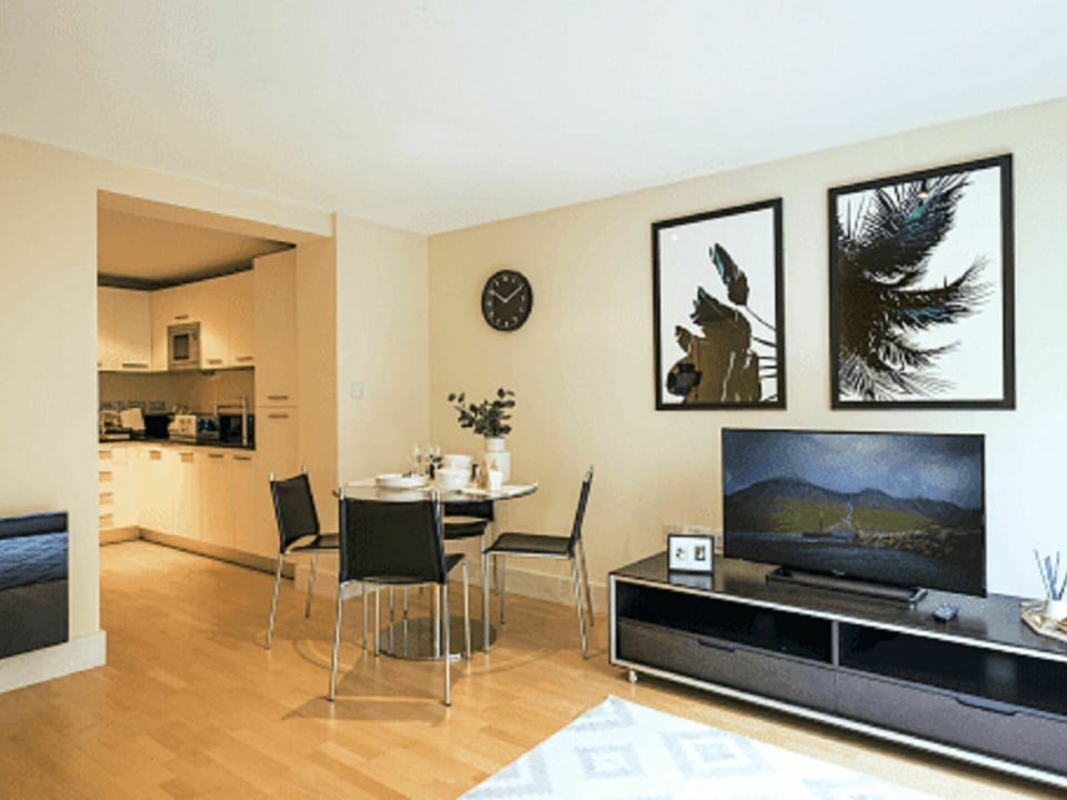 Furniture, Property, Table, Picture Frame, Couch, Building, Houseplant, Television, Wood, Home Appliance