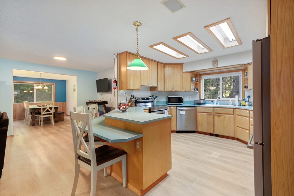 Open concept living with breakfast bar seating at kitchen.