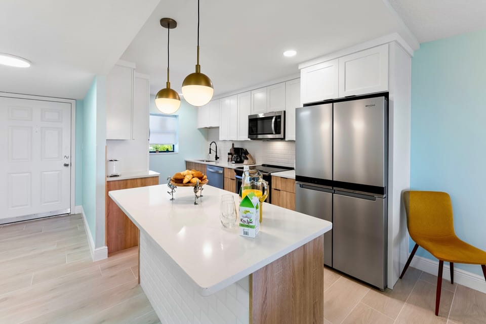 Brand new kitchen stocked with everything you need, featuring a spacious island and modern appliances.